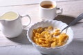 Corn Flakes cereal in a bowl, glass with milk and cap with espresso coffee. Morning breakfast. Royalty Free Stock Photo