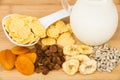 Corn flakes, dried fruits, sunflower seeds and milk Royalty Free Stock Photo