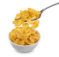 Corn flakes falling from spoon into bowl isolated on white background Royalty Free Stock Photo