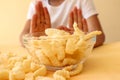 Corn flakes in a glass cup against the background of a child`s hands refusing to eat, close-up Royalty Free Stock Photo