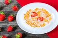 Corn flakes with milk and strawberries, close-up Royalty Free Stock Photo