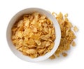 Corn flakes in a plate and scattered on a white background. Top view Royalty Free Stock Photo