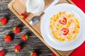 Corn flakes wirh milk and strawberries, top view Royalty Free Stock Photo