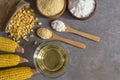 Corn flour, starch in wooden bowl, spoon with dried corn groats, kernels on rustic table Royalty Free Stock Photo