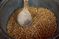 Corn grain in the cauldron with a wooden spoon Royalty Free Stock Photo