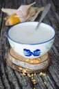 Corn grains cooked with milk on aged wooden background. Typical