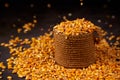 Corn grains in a jute bag and scattered grains around on a dark background Royalty Free Stock Photo