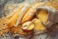 Corn groats and seeds, corncobs on wooden rustic table. Royalty Free Stock Photo