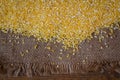 Corn groats on wood background