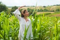 Corn growing. Young farmer in corn field, harvest concept. Young happy girl showing harvested corn in the field Royalty Free Stock Photo