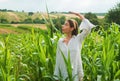 Corn growing. Young farmer in corn field, harvest concept. Young happy girl showing harvested corn in the field Royalty Free Stock Photo