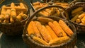 Corn is harvested and dried in sun in baskets and crates on backyard or agricultural farm. Soft focus. Close-up