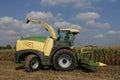 A combine harvester in front of a corn field Royalty Free Stock Photo