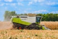 Corn harvesting with reaping-machine threshing-machine. Agricultural machinery. Harvester tractor - cereals - grain Royalty Free Stock Photo