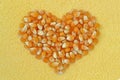 Corn kernels heart on maize flour background