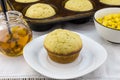 Corn muffin in plate with muffins in pan, syrup and corn in a bo Royalty Free Stock Photo