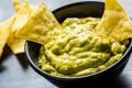 Corn nacho chips and avocado dip. Yellow tortilla chips and guacamole Royalty Free Stock Photo