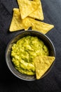 Corn nacho chips and avocado dip. Yellow tortilla chips and guacamole Royalty Free Stock Photo