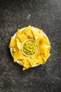 Corn nacho chips and avocado dip. Yellow tortilla chips and guacamole Royalty Free Stock Photo