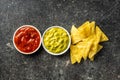 Corn nacho chips and avocado dip. Yellow tortilla chips and guacamole Royalty Free Stock Photo