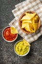 Corn nacho chips with avocado and tomato dip. Yellow tortilla chips and guacamole salsa Royalty Free Stock Photo