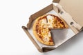 Corn pizza in a cardboard open delivery box on a white background. A piece is missing from the box. Top view Royalty Free Stock Photo
