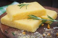 Corn polenta slices on wooden board