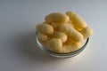 Corn Puffs in a Glass Bowl. Crunchy Flavored Puffed Snacks. Party, Movie Snacks Royalty Free Stock Photo