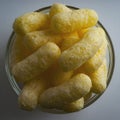 Corn Puffs in a Glass Bowl. Crunchy Flavored Puffed Snacks. Party, Movie Snacks Royalty Free Stock Photo