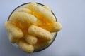 Corn Puffs in a Glass Bowl. Crunchy Flavored Puffed Snacks. Party, Movie Snacks Royalty Free Stock Photo