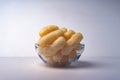 Corn Puffs in a Glass Bowl. Crunchy Flavored Puffed Snacks. Party, Movie Snacks Royalty Free Stock Photo