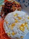 Corn rice with fried egg, spicy anchovies and shredded carrot