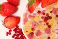 Corn rings with milk in a plate with berries and fruits, viewed from above on a white background. The concept of quick Royalty Free Stock Photo