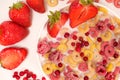 Corn rings with milk in a plate with berries and fruits, viewed from above on a white background. The concept of quick Royalty Free Stock Photo