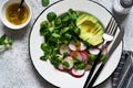 Corn salad with avocado and radish with mustard and honey sauce. Vitamin salad, top view