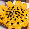 Corn salad decorated with potato chips and olives Royalty Free Stock Photo