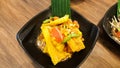 Corn salad with vermicelli and salted crab on black dish