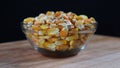 Corn seeds on the glass bowl with black and woooden table