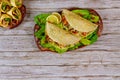 Corn soft tortillas stuffed with lettuce, meat and cheese on wooden background. Mexican dish Royalty Free Stock Photo