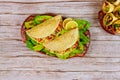 Corn soft tortillas stuffed with lettuce, meat and cheese on wooden background. Mexican dish Royalty Free Stock Photo