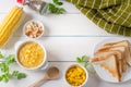 Corn soup in white bowl and crispy bread, toast corn with pepper on white table. Top view with Copy space Royalty Free Stock Photo