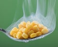 Corn in spoon with steam