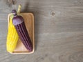 The corn stalks boiled and delicious on the wooden dish and the dish on wooden table. The color of corn is yellow and brown. copy Royalty Free Stock Photo
