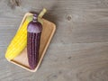 The corn stalks boiled and delicious on the wooden dish and the dish on wooden table. The color of corn is yellow and brown. copy Royalty Free Stock Photo