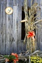 Corn Stalks and bows on the side of a country barn.