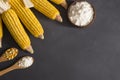 Corn starch in wooden bowl and spoon with dried corn groats