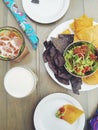 Corn tortilla chips and guacamole on table with cocktails Royalty Free Stock Photo