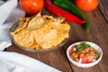 Corn tortilla chips with tomato salsa.