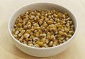 Corn in a white bowl on wooden table Royalty Free Stock Photo