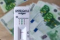 Corna virus self test and rapid antigen test for the covid-19 virus. test cassette with several euro banknotes. Making money